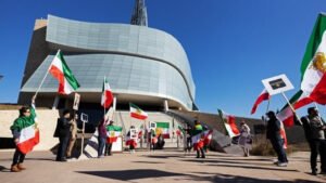 Rally participants waved flags and held signs outside the Canadian Museum for Human Rights on Sunday (Prabhjot Singh Lotey/CBC)