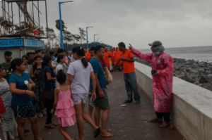 National Disaster Management officials instruct locals to stay behind flood barries when the storm hits. IT