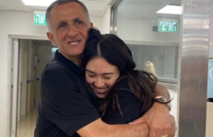 Noa Agramani hugs her father back in Israel. AP